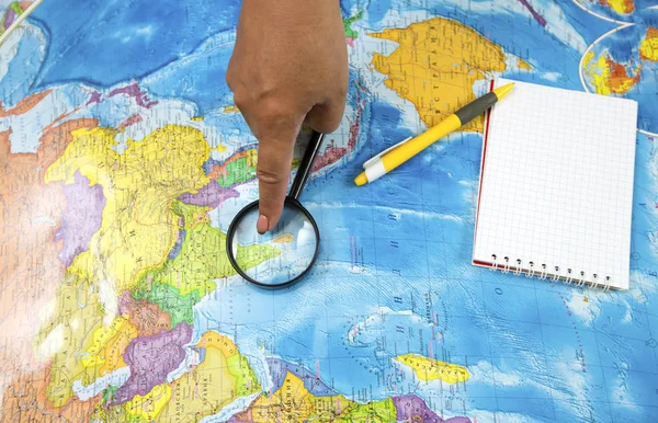 Search for new bright places to travel on the map and looking at the magnifying glass