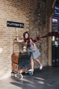 Londra, İngiltere - 26 Temmuz 2018: King's Cross istasyonuna, Londra, istasyonuna Hogwarts okul öğrencileri Hogwarts Express giden yer içinde peron 9 3/4 tarafından fotoğraf çekmek insanlar.