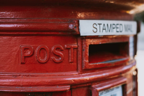 Close up of a red post box in London, UK, shallow focus.
