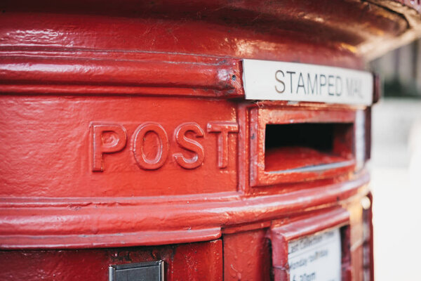 Close up of a red post box in London, UK, shallow focus.
