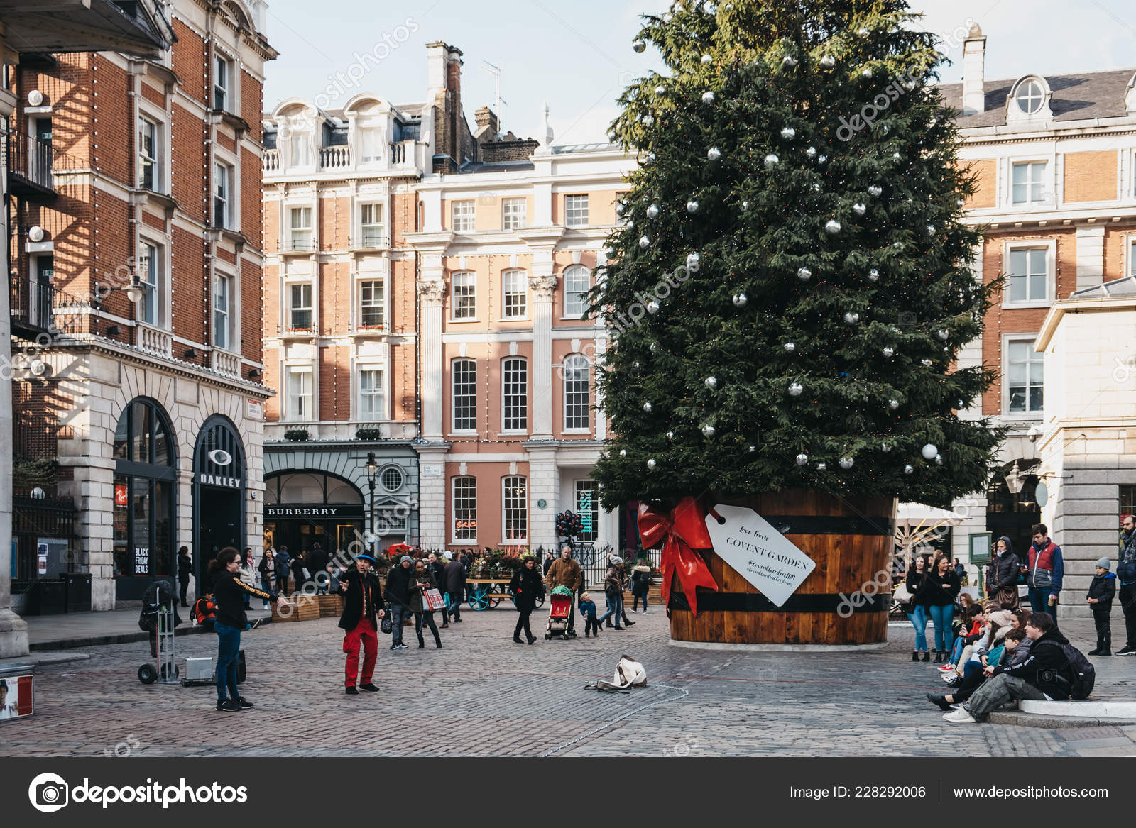 Giant Christmas Tree In A Pot With A Gift Tag In Front Of Covent