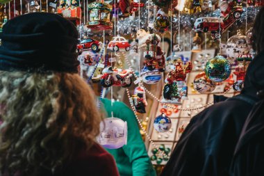 Arkadan Görünüş kimliği belirsiz kişi Noel süslemeleri Noel dünya Rathausplatz üzerinde geleneksel Noel Pazar Viyana'da gıda, içki ve el sanatları sunan 150'den fazla kabinleri ile tarama.