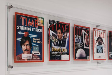 Prague, Czech Republic - August 28, 2018: Time magazines with Steve Jobs on the cover inside Apple Museum in Prague, the largest private collection of Apple products around the world. clipart