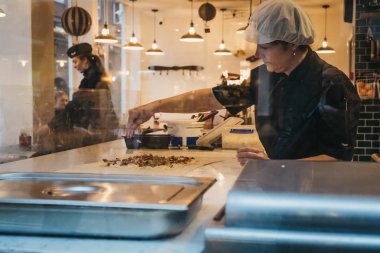 Londra, İngiltere - 5 Ocak 2019: Covent Garden, Londra, İngiltere, bir restoranda görünümü dışında içinde gıda hazırlama kadın. Covent Garden Londra mağazalar ve restoranlarla dolu bir ünlü turistik bölgedir.