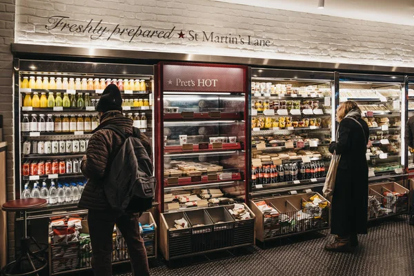 London, UK - January 5, 2018: People choosing food inside Pret a Manger, a popular international sandwich shop chain that is based in UK and has approximately 500 shops in nine countries.