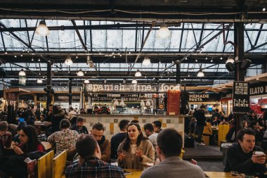 London, UK - January 13, 2019: People at Spanish food stand in Mercato Metropolitano, the first sustainable community market in London focused on revitalising the area and protecting environment.
