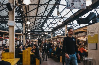 London, UK - January 13, 2019: People inside Mercato Metropolitano, the first sustainable community market in London focused on revitalising the area and protecting environment.