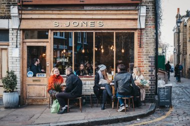 Londra, İngiltere - 03 Şubat 2019: S. Jones kafe dışında Erza sokakta oturan, Columbia yol çiçek pazarı ziyaret ettikten sonra rahatlatıcı insanlar, Doğu Londra'da bir semt pazarı her Pazar günü açık mı.
