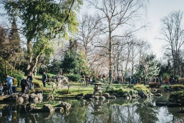 People walking inside Kyoto Garden in Holland Park, London, UK,  clipart