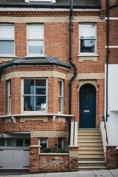 Black door on a facade of traditional English house in London, U