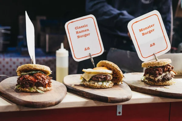 Oriental ramen burgers on sale inside Greenwich Market, London, Stock Picture