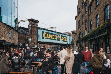 People walking past food stalls inside Camden Market, London, UK clipart