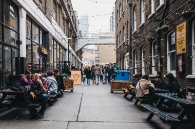 İnsanlar Ely 's Yard, Brick Lane, East lond 'da sokak yemeklerinin tadını çıkarıyor