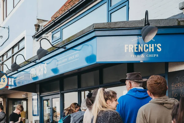 People queuing outside for take away from Frenchs, fish and chip