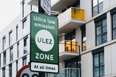 Signs indicating Ultra Low Emission Zone (ULEZ) on a street in L clipart