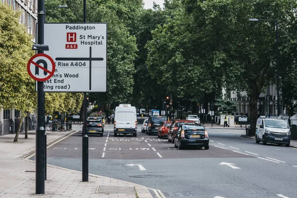 Autos parken richtungsweisende Verkehrsschilder auf einer Straße in London, Großbritannien — Stockfoto