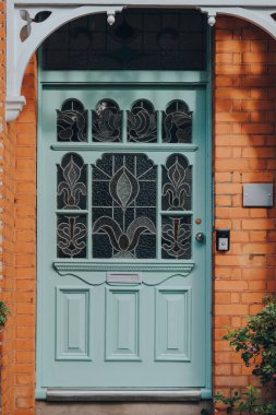 Londra, İngiltere - 26 Mayıs 2020: Londra 'da bir Edwardian evinin vitraylı ön kapısını kapatın, seçici odak noktası. Edwardian tarzı basit bir tasarım ve el yapımı için bir takdir sunar..
