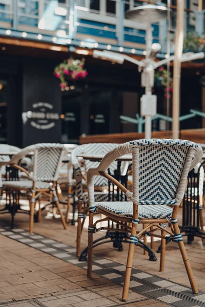 Outdoor chairs and tables of a restaurant, selective shallow focus.