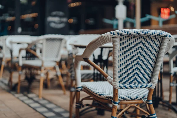 Outdoor chairs and tables of a restaurant, selective shallow focus.