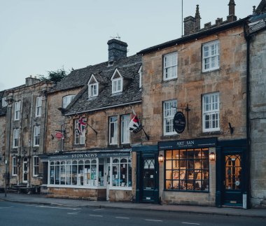 Stow-on-the-Wold, İngiltere - 6 Temmuz 2020: Cotswolds 'da bir pazar kasabası olan Stow-on-the-Wold' da kapalı dükkanlar sırası Roman Fosse Yolu üzerine inşa edildi. Seçici odak.