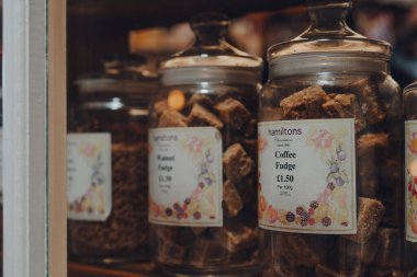 Broadway, İngiltere - 7 Temmuz 2020: Hamiltons, Worcestershire, İngiltere 'de Cotswolds' da büyük tarihi bir köy olan Broadway 'deki bir dükkanın vitrinindeki kavanozlarda şekerleme seçici bir odak noktası.