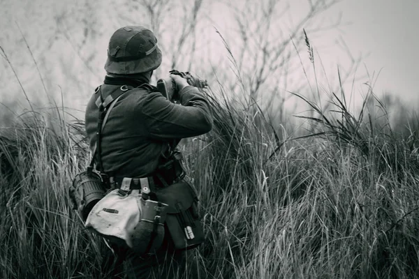 Black and White shot of a German soldier shooting out of cover — Stock Photo, Image