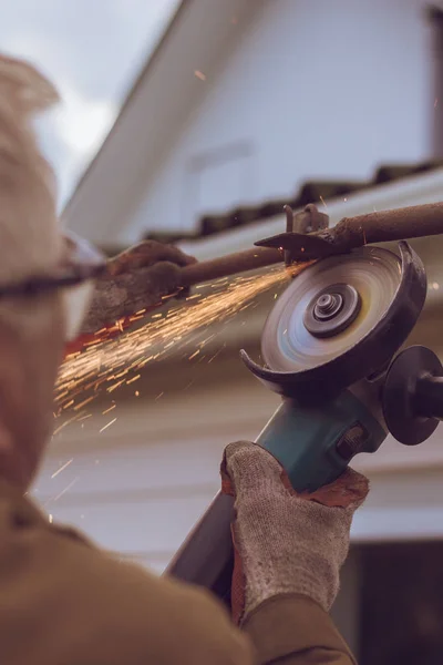 Work grinder worker cuts metal