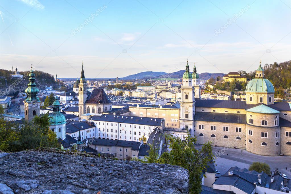 Panoramic view of Salzburg from castle of Hochsaltsburg on Salzburg Cathedral (Salzburger Dom), houses and mountains of Alps on horizon, Austria