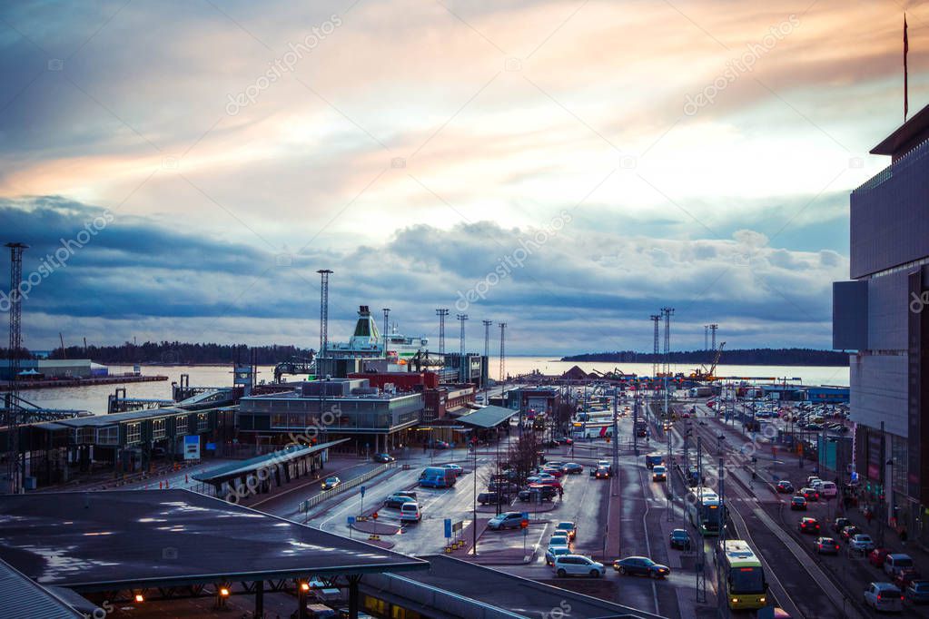Panoramic view of passenger port with ships and cruise liners and huge car parking in early morning with beautiful dawn  sunrise, Helsinki, Finland