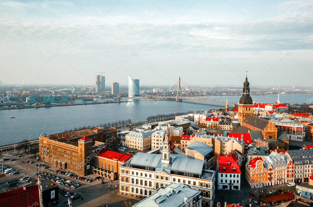 Panoramic view of old town with bright colorful houses and Riga Dome Cathedral, bridge over Daugava river in Riga, Latvia. Beautiful cityscape, top view.