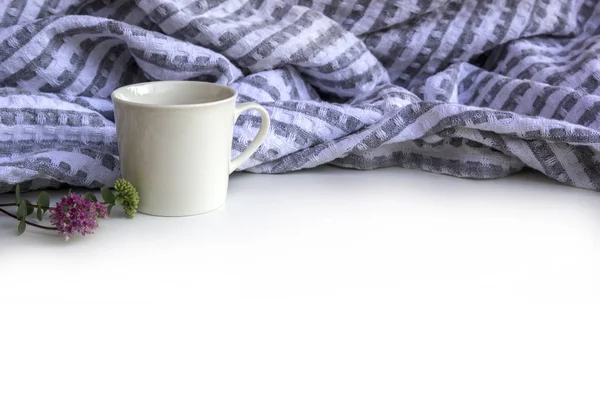 Summer or spring composition - cup of coffee, flowers and plaid on white background, copy space.