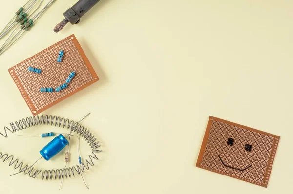 Blank circuit board with emoji face made of resistors