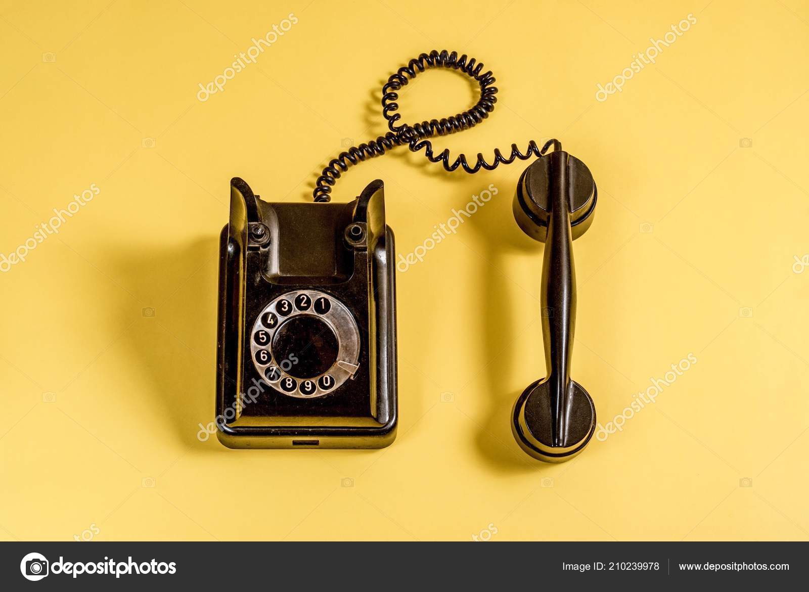 Vintage Black Telephone Headset Coiled Cable Yellow Background Stock