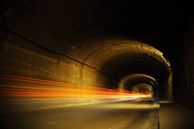 Hareketli ışıklı karanlık tünel. Parlak ışık hatları ile eski tünel. 