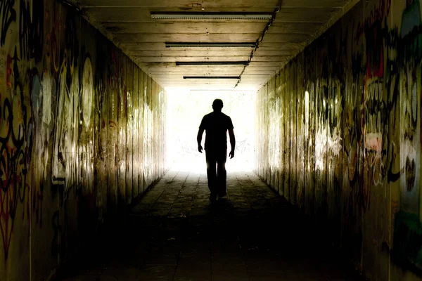 Silhouette Man Going Dark Tunnel Bright Light — Stock Photo, Image