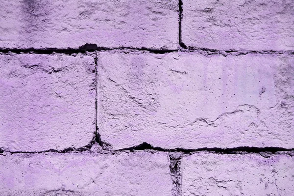 Rough concrete brick layer in purple. Purple wall backgroud.