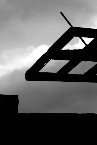 Abandoned and ruined parking lot ceiling in black and white. Ruined concrete structure with a dramatic sky background.