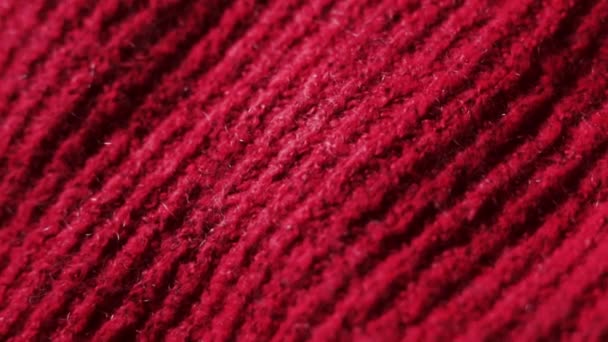 В'язана тканина в червоному кольорі. Може використовуватися як тло . — стокове відео