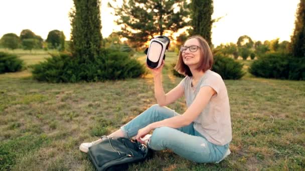 Joyeux jeune fille en lunettes utilise des lunettes VR dans la soirée . — Video