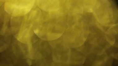 Sarı colord bokeh, bulanık cam parçacıkları. Soyut hareketli arka plan.