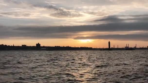 Silhouet van een vuurtoren bij zonsondergang. — Stockvideo