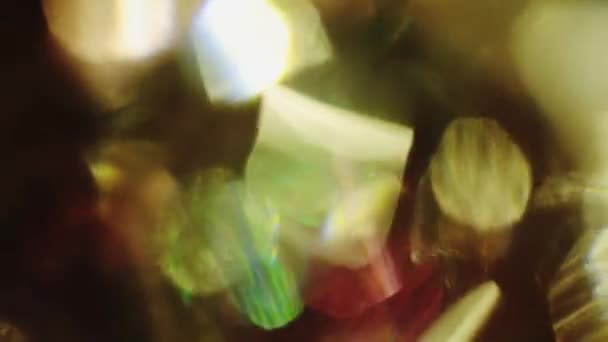 Multicolored crystalline reflections pour in the darkness. — Stock Video