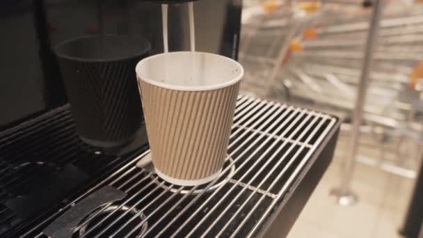 Gießen Dampf von Kaffee und Milch aus professionellen Maschine in Tasse. Morgens gerösteten schwarzen Kaffee trinken. — Stockvideo