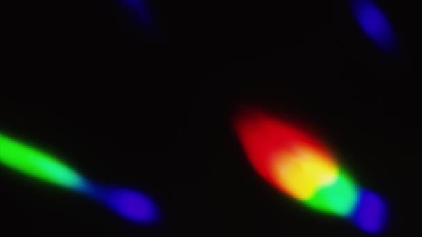 Light spots of red, blue, green and yellow wander in the dark. — Stock Video