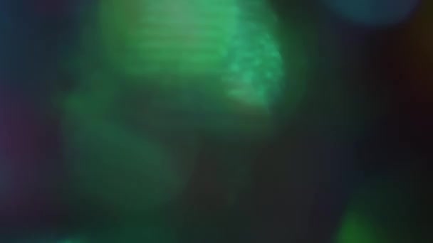 Cyberpunk defocused light spots glows chaotic in dark room. — Stock Video