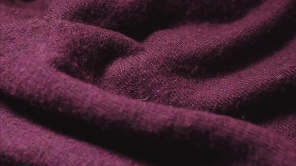 Detailed shot of burgundy color synthetic sweater in a textiles shop. — Stock Video