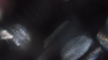 Siyah arka planda titreşen modaya uygun ışık parçacıkları. 