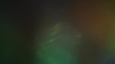 Döngülü renkli arka plan. Sürrealist ışık geçişleri. Koyu arkaplanda parlayan ışık huzmeleri.