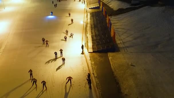 Légi felvétel: síelők a lejtőn lefelé megy, téli éjszakában. Ski verseny — Stock videók