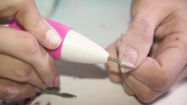 Chica en casa elimina el esmalte de uñas con una máquina especial para prepararse para una manicura. Primer plano — Vídeos de Stock